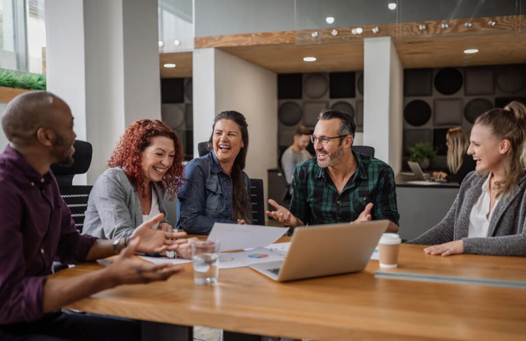 Smiling group of businesspeople talking together during an office